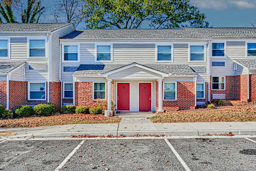 an apartment building with a red door