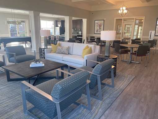 A living room with a grey couch and a coffee table.
