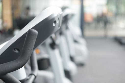 a row of bikes parked in a parking lot