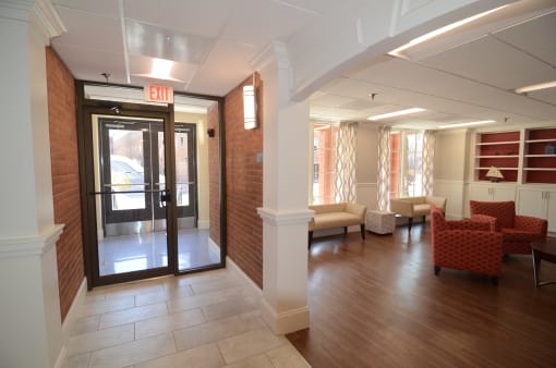a view of the entrance to the leasing office with couches and chairs