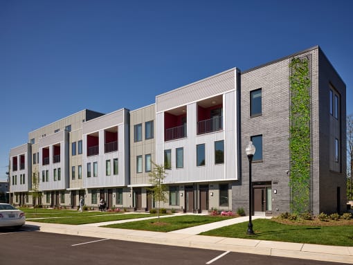 a view of the front of a building with a sidewalk and grass