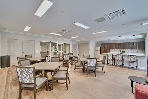 A large room with a dining table and chairs.