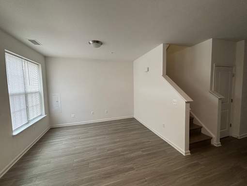 A room with a staircase and a window.