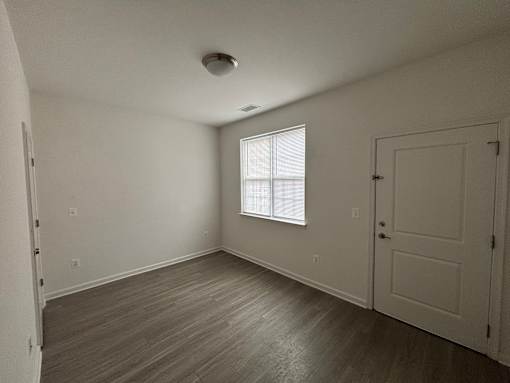 A room with a window and a door.