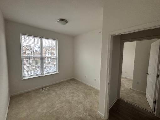 A room with a window and a door.
