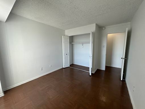 A room with white walls and a wooden floor.