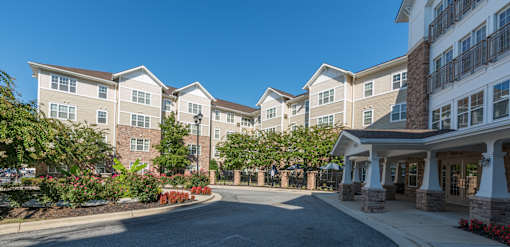 A large building with a driveway in front of it.