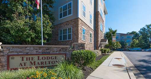 The Lodge at Marlton sign in front of a building.