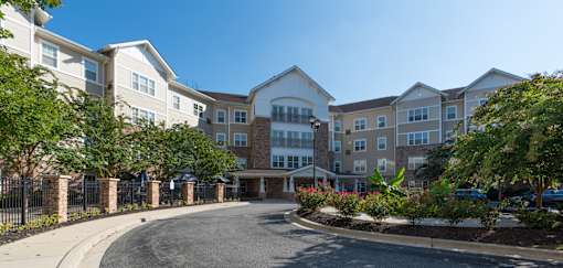 A large apartment complex with a driveway in front.