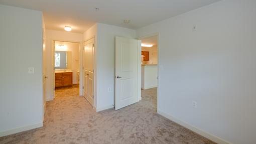 A room with a carpeted floor and white walls.