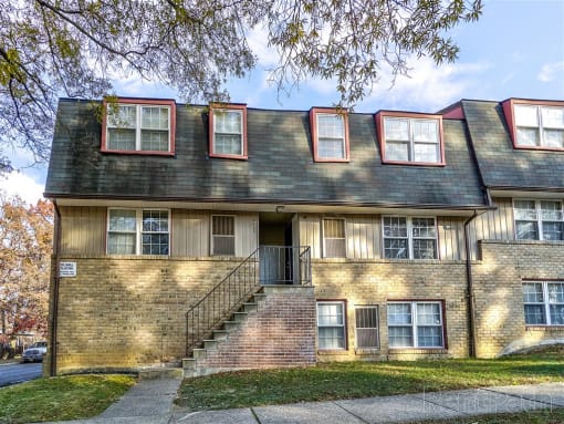 Outer view of Northern Village apartment building with a staircase in front of it