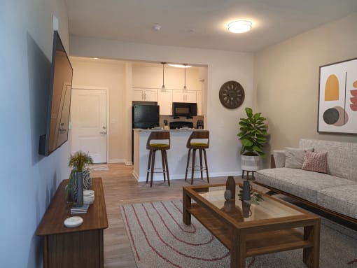 a living room and kitchen with a couch and a table