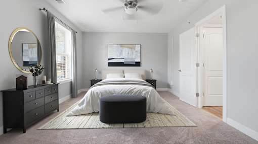 A bedroom with a large bed, a dresser, and a mirror.