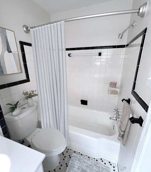 A white bathroom with a toilet, sink, and bathtub.