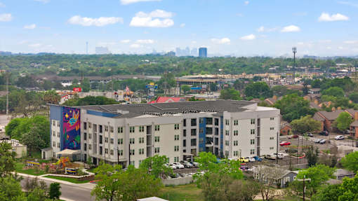 A large white building with a colorful mural on the side.
