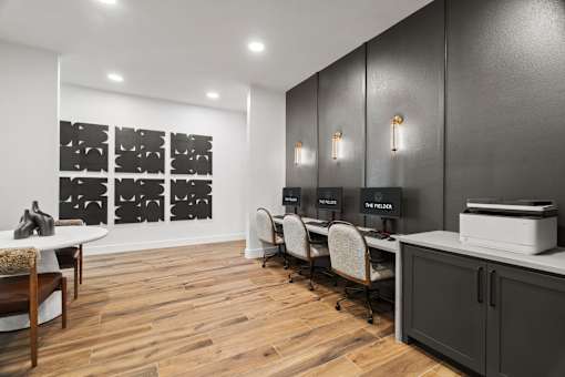 Work-from-home amenity space featuring computer stations, collaborative work areas, and modern business center amenities.