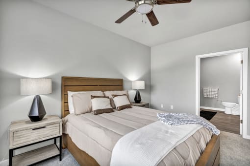 a bedroom with a large bed and a ceiling fan