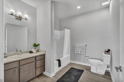 a white bathroom with a toilet sink and shower