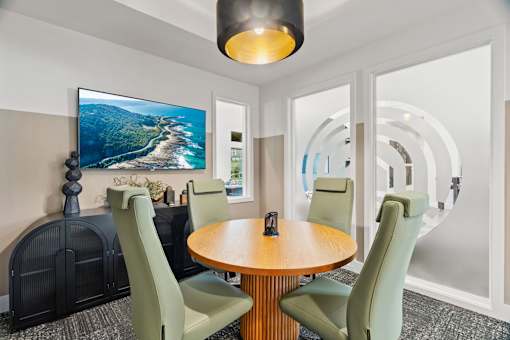 Work-from-home amenity space featuring computer stations, collaborative work areas, and modern business center amenities.