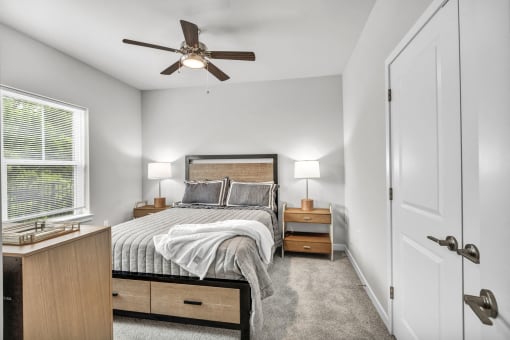 a bedroom with a bed and a ceiling fan
