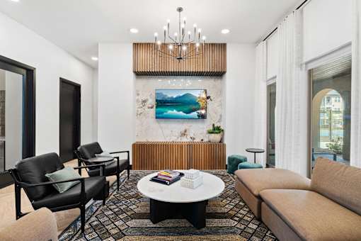 a living room with couches and chairs and a table