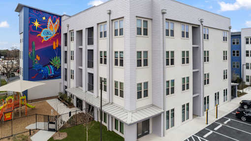 A white building with a mural on the side.