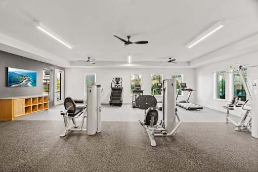 Resident fitness center featuring cardio and strength-training equipment in a modern, spacious workout environment.