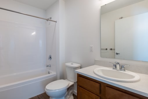 an empty bathroom with a sink toilet and shower