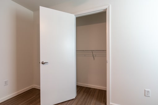 an empty closet in a room with a door open