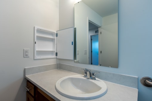 an empty bathroom with a sink and a mirror