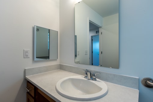 an empty bathroom with a sink and a mirror