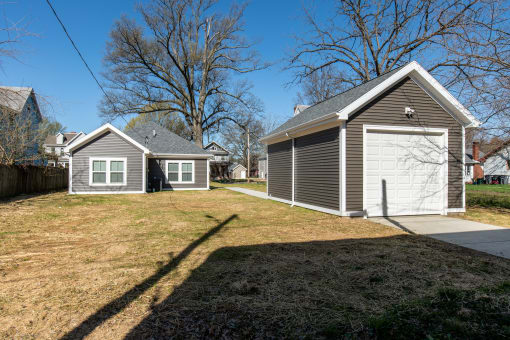 a backyard with a garage and a house