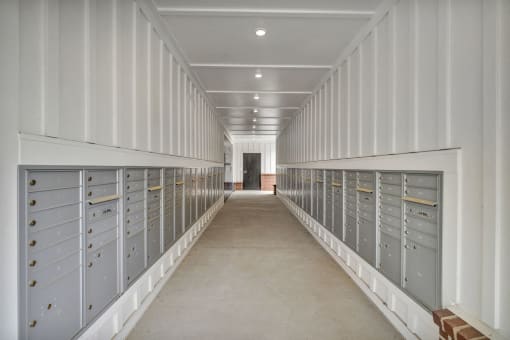 a long hallway with lockers in a white room