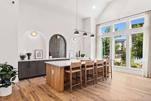 Resident clubhouse featuring bar-height seating, refreshment station, and open gathering space for socializing and community events.