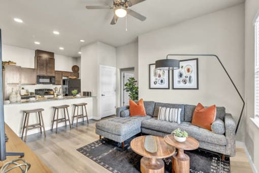 a living room with a couch and a kitchen with a bar