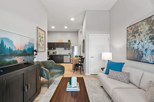 Contemporary apartment living room featuring stylish seating, high ceilings, and natural light.