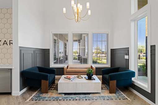 a room with two blue chairs and a white coffee table
