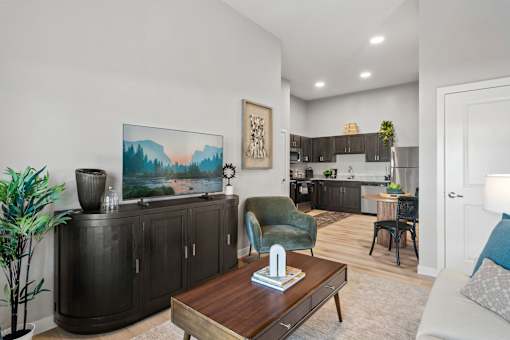 Apartment living room featuring comfortable seating, abundant natural light, and contemporary interior finishes.
