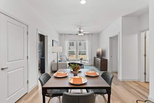 Modern apartment dining room at The Esther apartments with dining table and chairs.
