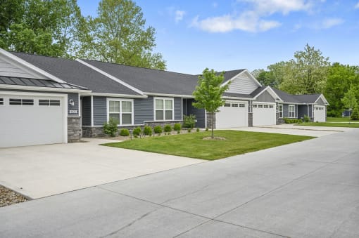 a house with a driveway and a lawn in front of it