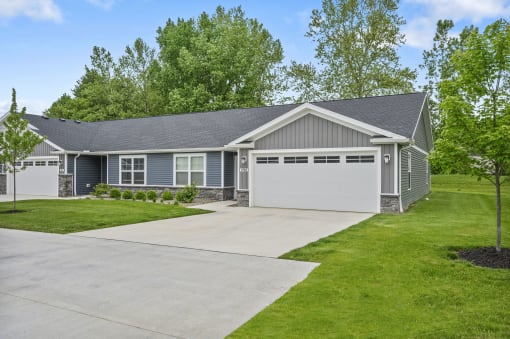 the front of a house with a driveway and a garage door