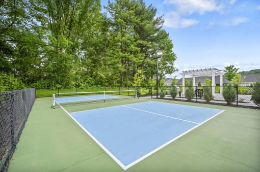 a blue and green tennis court with a net on top of it