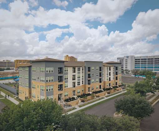 A large apartment complex with multiple buildings and balconies.