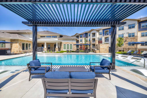 our apartments offer a swimming pool with lounge chairs and a pergola