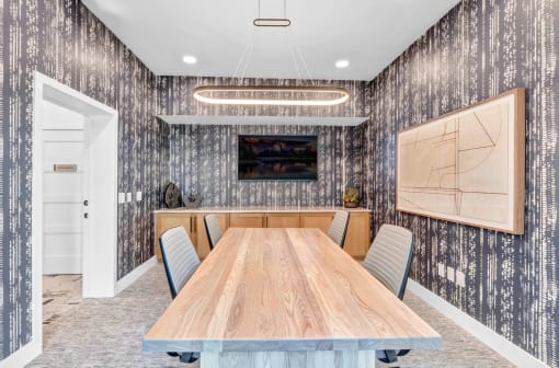 a dining room with a wooden table and chairs
