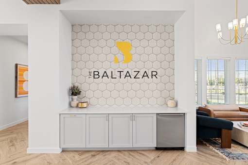 a white counter with a counter and a logo on the wall
