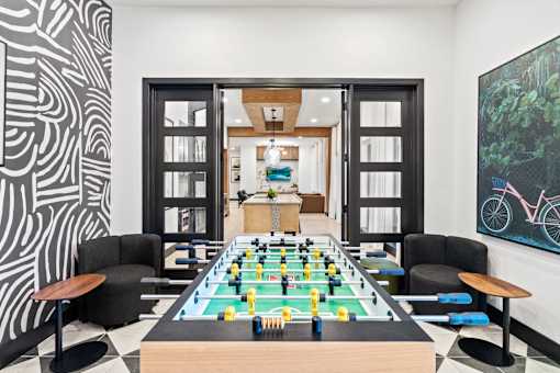 a game room with a foosball table and a wall mural