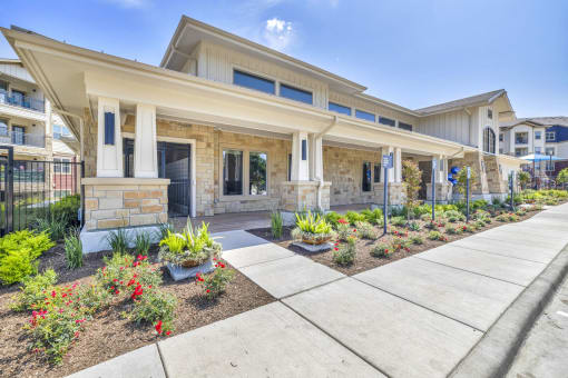 the front of a house with a walkway and landscaping