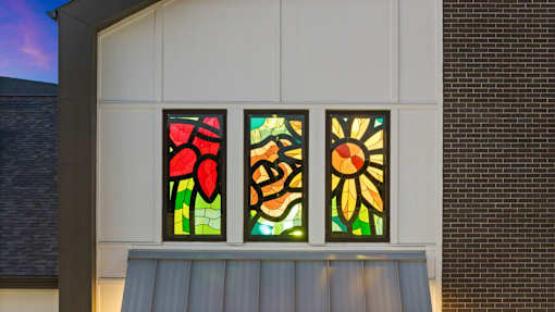 Three mural-style stained glass windows in The Esther clubhouse in Converse, TX.