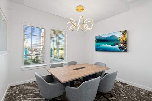 a conference room with a wooden table and chairs